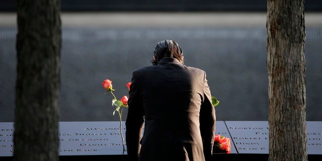 Sept. 11, 2017: A man stands at the edge of a waterfall pool at ground zero during a ceremony on the 16th anniversary of the 9/11 attacks in New York.