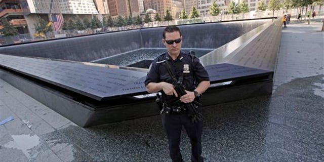 Sept. 9: A heavily armed Port Authority police officer stand guard next to the North Pool at the World Trade Center memorial site Friday, in New York. Just days before the 10th anniversary of the Sept. 11 attacks, U.S. counterterrorism officials are chasing a credible but unconfirmed al-Qaida threat to use a car bomb on bridges or tunnels in New York City or Washington.