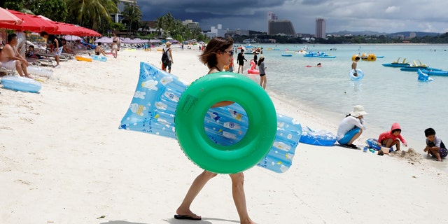 Tourists frolic along the Tumon beach on the island of Guam, a U.S. Pacific Territory, August 10, 2017.