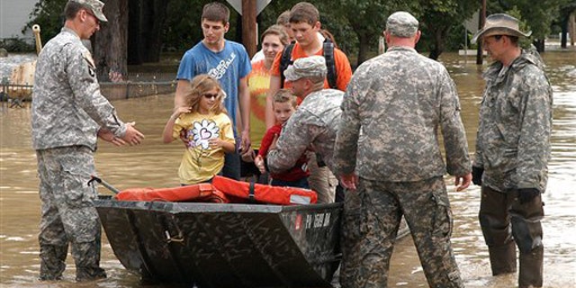 The Army National Guard is shown rescuing residents from their home Sept. 9 in West Pittston, Pa., amid high floodwaters.