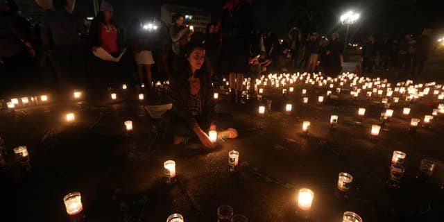 Members of the Family Survivors Foundation attend a candlelight vigil in honor of the victims of a fire that broke out at a children's shelter in Guatemala, March 8, 2017.