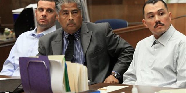 FILE - In this May 31, 2012 file photo, Marvin Norwood , left, with attorney Victor Escobedo, center, and co-defendant Louie Sanchez appear during a preliminary hearing held in Los Angeles Superior court. The two men have pleaded guilty on Thursday, Feb. 20, 2014 in Los Angeles to a 2011 beating at Dodger Stadium that left San Francisco Giants fan Bryan Stow brain damaged and disabled. (AP Photo/Los Angeles Times, Irfan Khan, Pool, File)