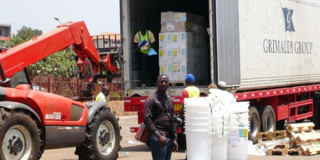 Workers from Doctors Without Borders unload emergency medical supplies to deal with an Ebola outbreak in Conakry, Guinea, March 23, 2014. (REUTERS/Saliou Samb)