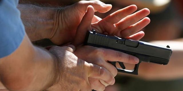 A New Jersey high school came under fire Friday after it allegedly suspended two students over a gun photo taken during a family visit to a shooting range.