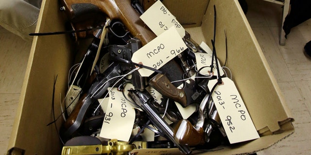 Jan. 26, 2013: Hand guns are seen in a box in Trenton, N.J., during a gun buyback event.