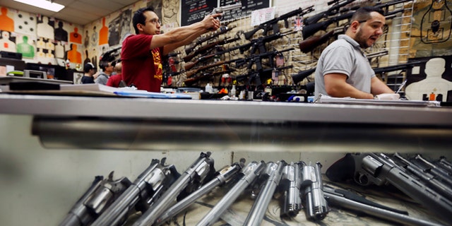 Jan. 23, 2013: Employees demonstrate gun safety to clients at the Los Angeles gun club in Los Angeles.