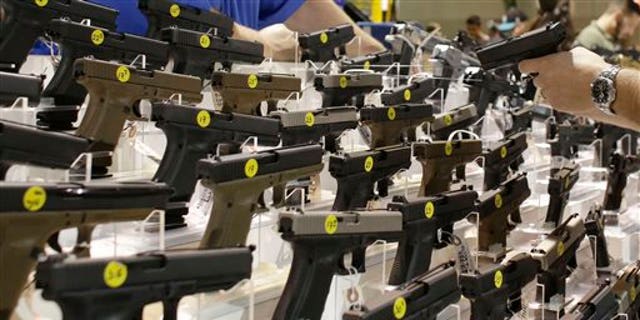 Firearms are on display at a gun show in Miami, Fla., on Jan. 9, 2016. (AP Photo/Lynne Sladky)