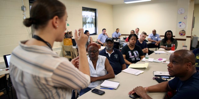 In this Saturday, July 9, 2016 photo, Dr. Zoe Maher, a Temple trauma surgeon, explains the Philadelphia Immediate Transport in Penetrating Trauma Trial (PIPT) to community leaders, at the Hunting Park Community Center, in Philadelphia. The difference between being a gunshot survivor or a homicide victim may be what happens in the ambulance. Several Philadelphia hospitals are coming together for a study that will ask: When gunshot victims are rushed to the emergency room, could paramedics do more to save them by doing less? (AP Photo/ Joseph Kaczmarek)