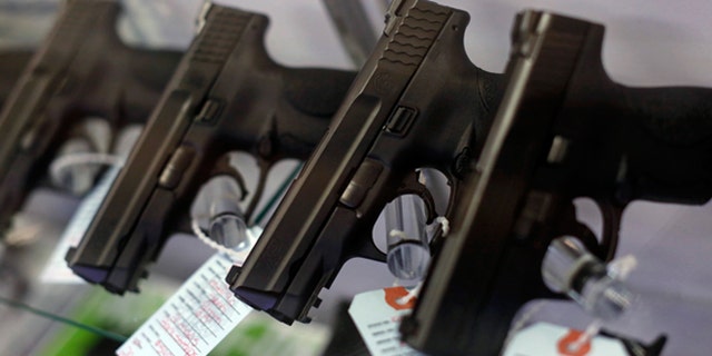 Nov. 13, 2014: Handguns are seen for sale in a display case at a gun store in Bridgeton, Mo.
