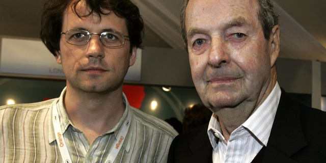 FILE In this file photo, dated Saturday May 14, 2005, Frederick Baker, the Anglo-Austrian director of "Shadowing The Third Man", left, and Britain's Guy Hamilton, director of four James Bond films, pose prior to their joint press conference at the 58th international Cannes film festival in Cannes, southern France. A hospital on his home island of Mallorca said he died aged 93 on Wednesday April 20, 2016. (AP Photo/Michel Euler, FILE)