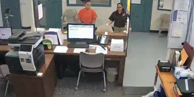 Amber Guyger, left, in orange jumpsuit, surrendered to police after she fatally shot Botham Jean in his own apartment.