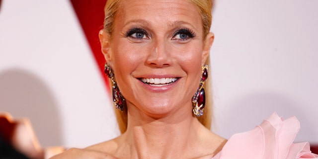 Actress Gwyneth Paltrow, wearing a custom Ralph & Russo pink one sleeve gown with a giant flower on the shoulder, arrives at the 87th Academy Awards in Hollywood, California February 22, 2015. REUTERS/Lucas Jackson (UNITED STATES TAGS:ENTERTAINMENT) (OSCARS-ARRIVALS) - RTR4QP70