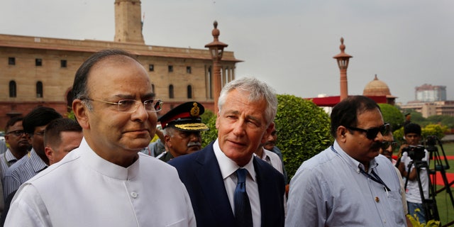 Aug. 8, 2014: U.S. Defense Secretary Chuck Hagel, center, talks with Indian Defense Minister Arun Jaitley as they walk for a meeting in New Delhi, India.
