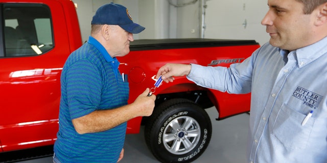 In this Thursday, Nov. 19, 2015, photo, Alton John, left, from Kittanning, Pa., gets the keys to his new 2015 Ford F-150 Supercab 4x4 pickup truck from salesman Robert Myers as he takes delivery at Butler County Ford in Butler, Pa. Haggling over a car price isnt for everyone. The angst has spawned a small but growing trend toward no-haggle alternatives found at discount club stores, some dealers and on several Internet sites. (AP Photo/Keith Srakocic)