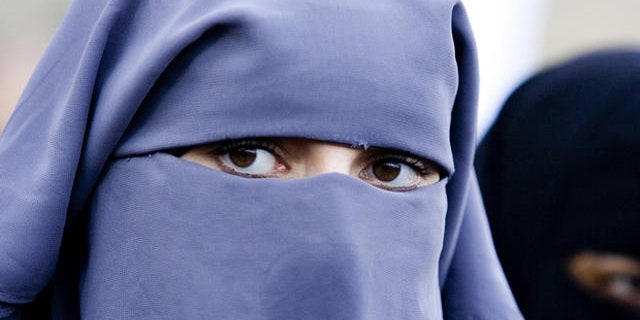 Unidentified women wearing a niqab during a demonstration of about two dozen Muslim women outside the Dutch parliament against a proposed ban on the burqa, the head-to-toe Islamic robe, in The Hague, Netherlands, Thursday, Nov. 30, 2006. Several protesters wore long robes and veils exposing only their eyes, known as a niqab. "We live in a free country and the government cannot tell us what to do with our religion," protest organizer Ayse Bayrak told The Associated Press. Hard line Immigration Minister Rita Verdonk is drawing up legislation banning the burqa and other clothes that cover the face in public places. (AP Photo/ Fred Ernst)