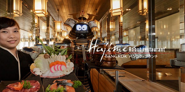 Hajime Robot Restaurant in Bangkok employs robots as their waitstaff. Diners sit facing a glass enclosure where the robots move back and forth on a track and serve customers through windows.