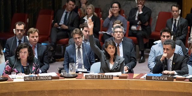 U.S. Ambassador to the United Nations Nikki Haley, center, votes in favor of a resolution introduced by the United States during a Security Council meeting on the situation between the Israelis and the Palestinians, Friday, June 1, 2018 at United Nations headquarters.