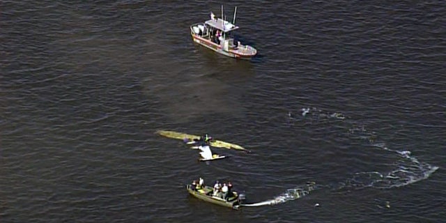 Rescue boats surround the wreckage of the plane Halladay was flying Tuesday.
