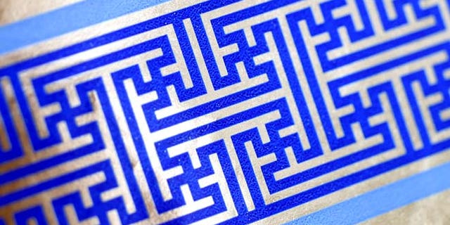 Dec. 8, 2014: Cheryl Shapiro displays the Hanukkah gift wrap with a swastika-like pattern she found at Walgreens in Northridge, Calif. The wrapping paper has been recalled from stores nationwide.