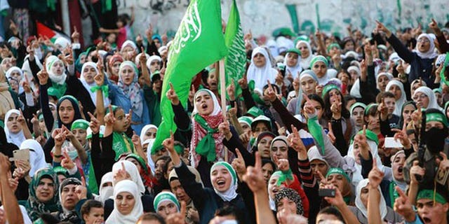Hamas supporters rally in the West Bank, where Palestinian Authority officials say the terror group is seeking to undermine it, with help from an operative in Turkey. (Reuters)
