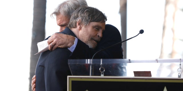 Fords hugs Hamill after his speech about his long-time costar and friend.