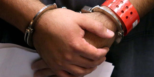 SANFORD, FL - NOVEMBER 19: Detail of the handcuffed hands of George Zimmerman, the acquitted shooter in the death of Trayvon Martin, faces a Seminole circuit judge during a first-appearance hearing on charges including aggravated assault stemming from a fight with his girlfriend November 19, 2013 in Sanford, Florida. Zimmerman, 30, was arrested after police responded to a domestic disturbance call at a house. He was acquitted in July of all charges in the shooting death of unarmed, black teenager, Trayvon Martin. (Photo by Joe Burbank-Pool/Getty Images)