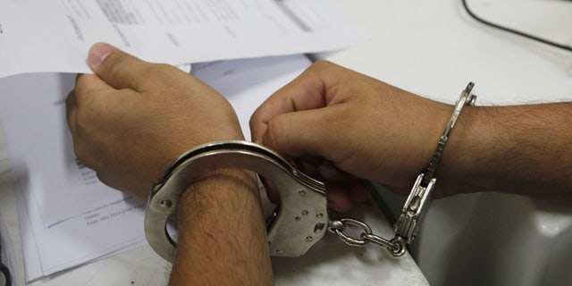 MANAUS, BRAZIL - FEBRUARY 18: A handcuffed inmate meets with an attorney to update his case in the overcrowded Puraquequara prison on February 18, 2016 in Manaus, Brazil. The prison holds nearly 1,400 inmates, around twice as many as it was designed for. Brazil now holds the fourth-largest prison population in the world, behind the U.S., Russia and China, with the number of Brazilians behind bars nearly doubling in the past decade. The prison system currently holds more than 600,000 inmates, 61 percent over capacity, according to Human Rights Watch. (Photo by Mario Tama/Getty Images)