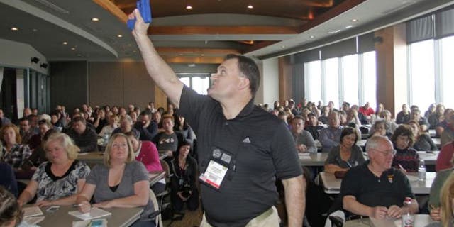 Dec. 27, 2012: Clark Aposhian, President of Utah Shooting Sport Council, demonstrates with a plastic gun during concealed-weapons training for 200 Utah teachers.