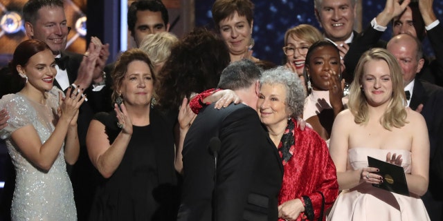 Atwood celebrates "The Handmaid's Tale" Best TV Drama win at the 2017 Emmy Awards with the show's cast.
