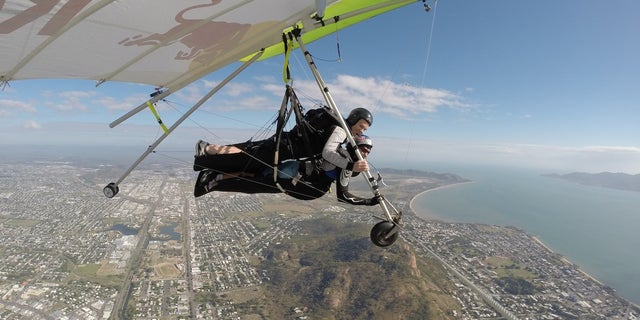Red Bull Racing Australia driver, Craig Lowndes, and world-record holding hang-glider Jonny Durand during a flight over Townsville, Australia, on July 3, 2014.
