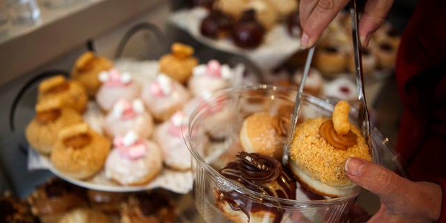 A customer picks doughnuts at a shop in Israel