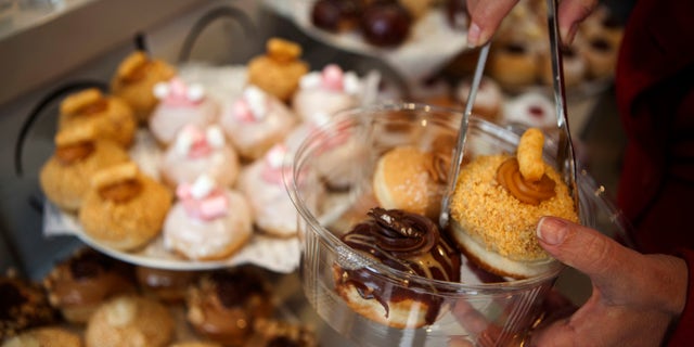 A customer picks doughnuts at a shop in Israel