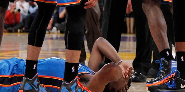 April 22, 2012: Oklahoma City Thunder players stand over teammate James Harden, lower left, after receiving a flagrant double foul from Los Angeles Lakers' Metta World Peace, who was then ejected, in the first half of an NBA basketball game in Los Angeles. (AP)