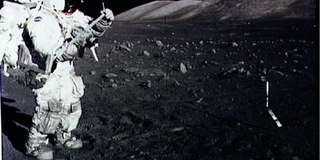 Astronaut Harrison Schmitt collects lunar rake samples during an Apollo 17 moonwalk in December 1973.