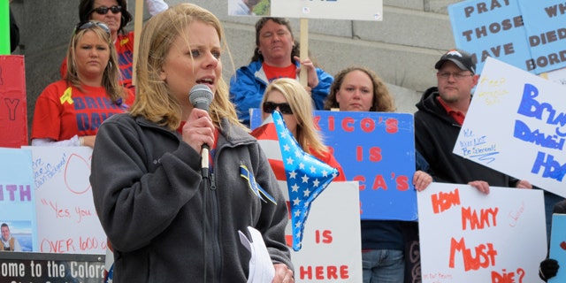 Tiffany Hartley speaks to a rally on the steps of the Colorado State Capitol in Denver.