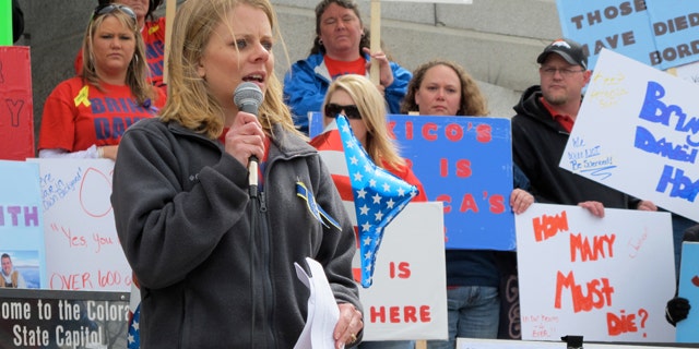 Tiffany Hartley speaks to a rally on the steps of the Colorado State Capitol in Denver.