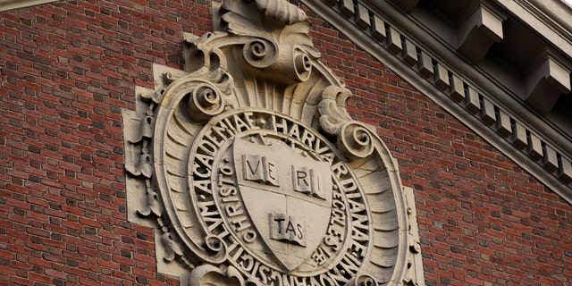 The university seal hangs over a building at Harvard University in Cambridge, Massachusetts, Nov. 16, 2012.