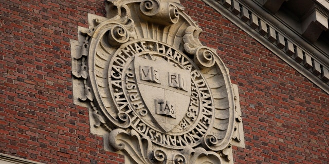 The university seal hangs over a building at Harvard University in Cambridge, Massachusetts, Nov. 16, 2012.