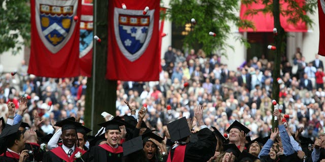 Harvard University Medical School graduates celebrate at commencement ceremonies by tossing giant pills in the air.