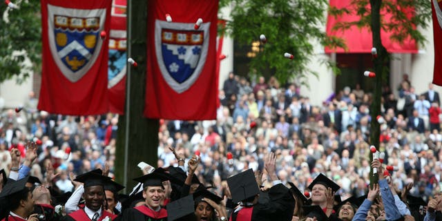 Harvard University Medical School graduates celebrate at commencement ceremonies by tossing giant pills in the air.