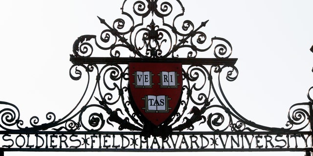 Harvard's seal sits atop a gate to the athletic fields at Harvard University in Cambridge, Mass., Sept. 21, 2009. 