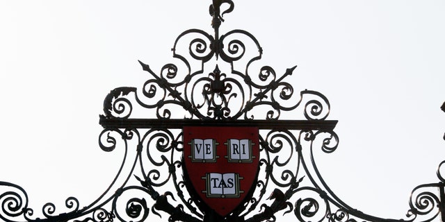 Harvard's seal sits atop a gate to the athletic fields at Harvard University in Cambridge, Massachusetts Sept. 21, 2009. 