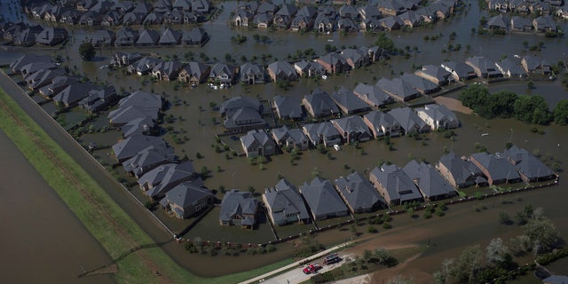 Emergency personnel stand at the entrance to neighborhood flooded by Tropical Storm Harvey in Southwest Houston, Texas, U.S. August 30, 2017. REUTERS/Adrees Latif TPX IMAGES OF THE DAY - RC1AE22B7220
