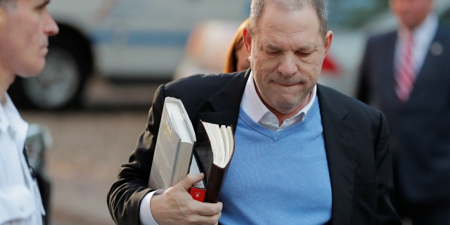 The disgraced film mogul walked into the police precinct with three books in hand.
