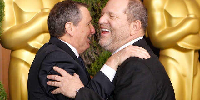 Tom Sherak, former president of the Academy of Motion Picture Arts and Sciences, hugs Harvey Weinstein at the 84th Academy Awards nominees luncheon. (2012)
