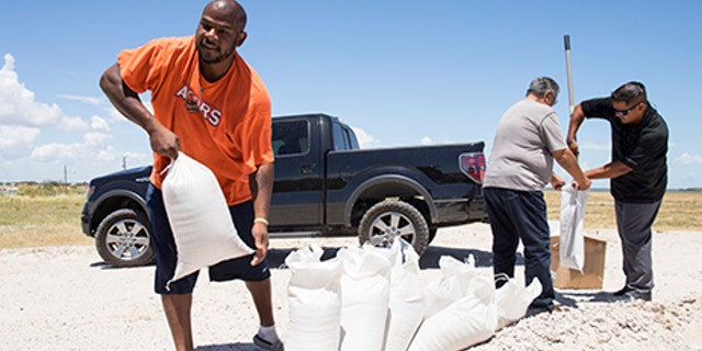 Residents fill sandbags on, August 23, 2017 to protect homes and businesses exposed by the threat of Tropical Storm Harvey.