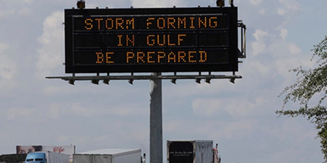 Motorists in Houston pass a sign warning of Hurricane Harvey as the storm intensifies in the Gulf of Mexico, Aug. 24, 2017.