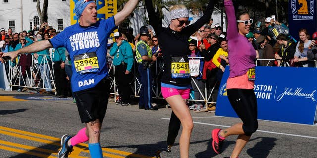 Bombing survivor and amputee Adrianne Haslet crossed the Boston Marathon finish line after more than 10 hours on the course. (photograph by Boston Globe/Getty Images)