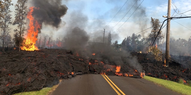 Lava advances along a street near a fissure in Leilani Estates, on Kilauea Volcano's lower East Rift Zone, Hawaii, the U.S., May 5, 2018.