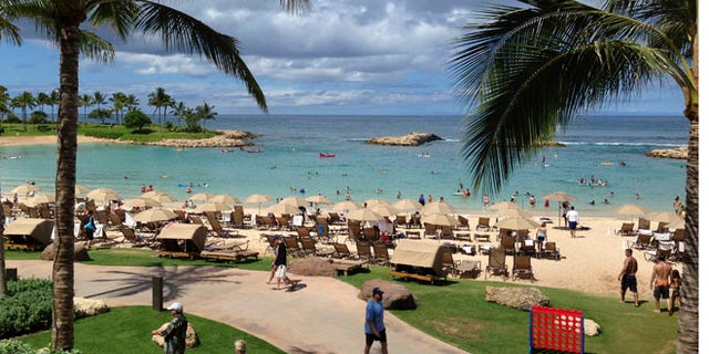 July 29, 2013: Tourists and locals play on Ko'Olina beach on the island of Oahu, Hawaii.